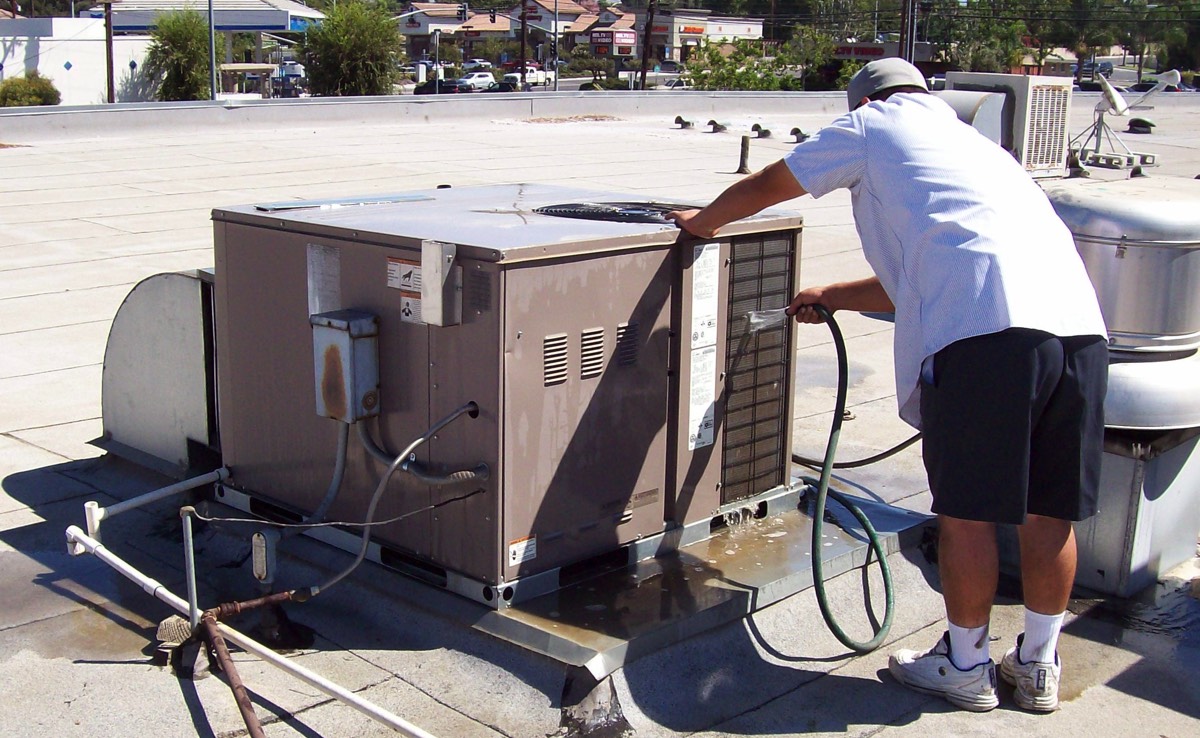 Cleaning roof mounted Packaged Heating and A/C System