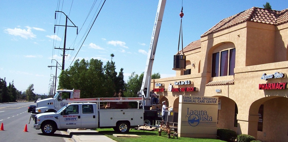 Lifting new A/C Unit to roof for replacement.